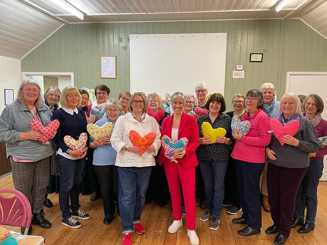 The whole of the Mead Quilters group with Daisy Cooper MP