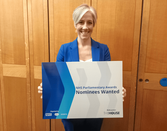 Daisy Cooper holding a board saying 'Nominees wanted'